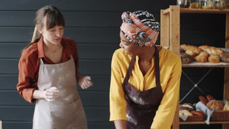 Multiethnic-Female-Bakers-Kneading-Dough-Together-and-Talking